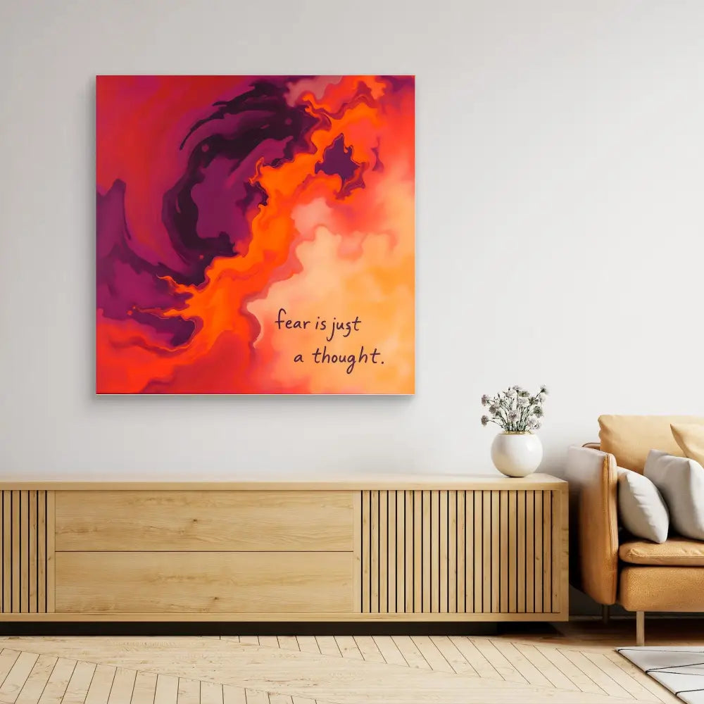 Abstract canvas artwork featuring swirling orange and purple clouds with text that reads ’Fear is just a thought.’