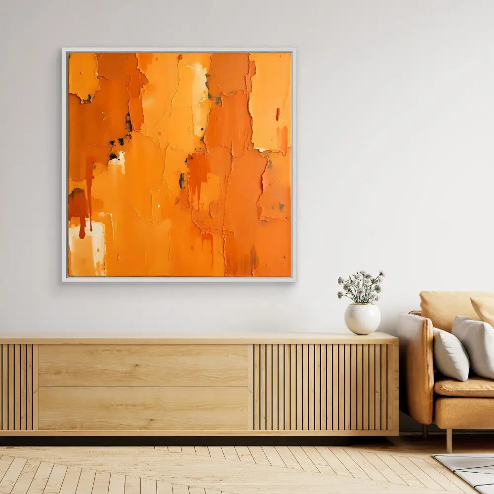 Abstract orange painting with white accents and dripping textures in a silver frame.