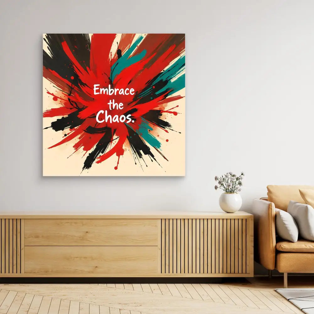 Abstract wall art featuring paint splatter patterns in red, turquoise and black with white text reading ’Embrace the Chaos.’