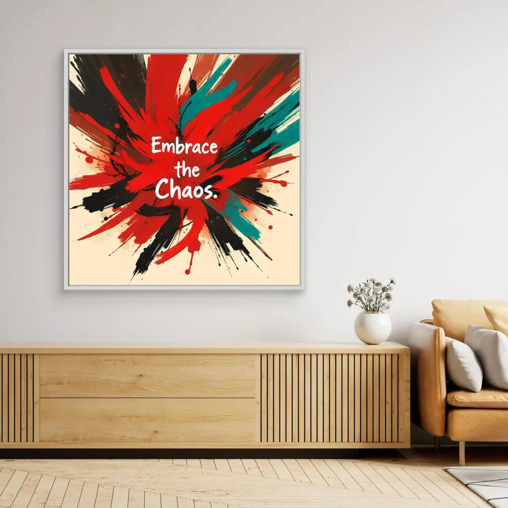 Abstract wall art featuring paint splatter patterns in red, teal and black with white text reading ’Embrace the Chaos’