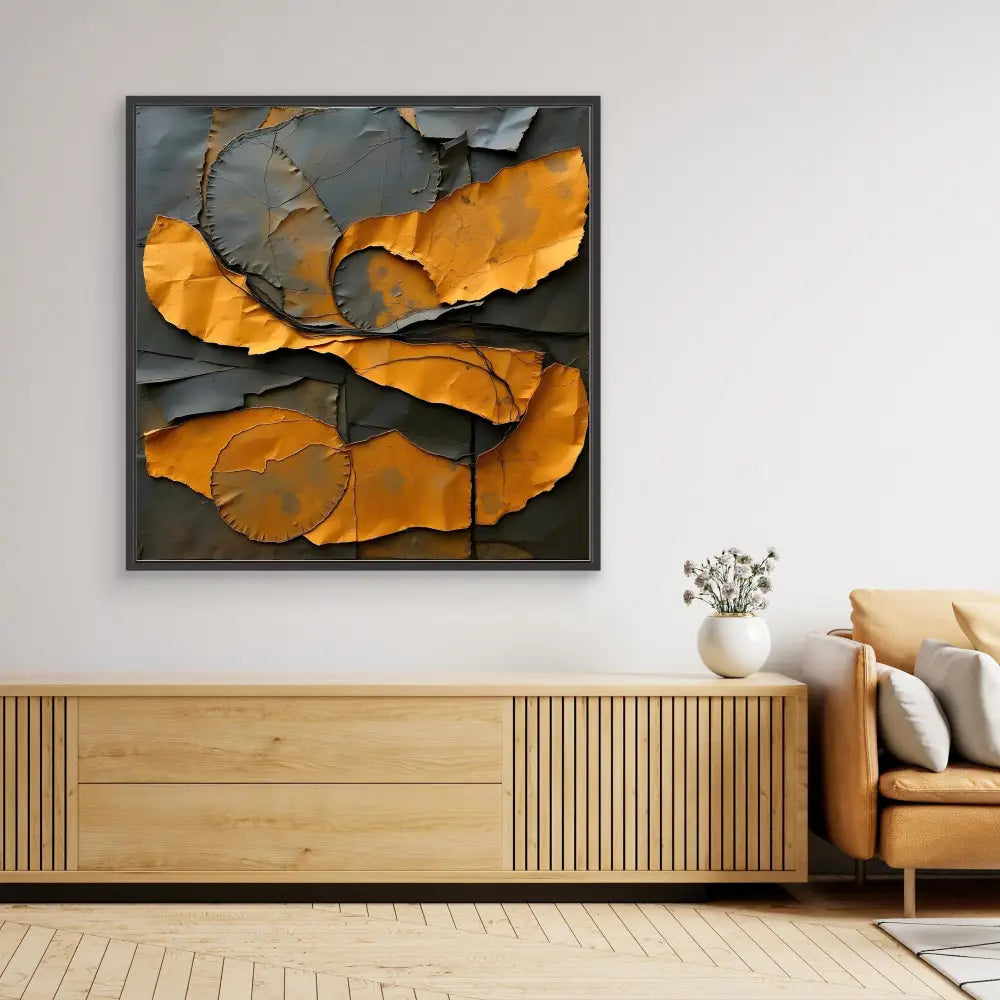 Abstract wall art featuring torn orange and gray paper-like shapes in a dark frame.