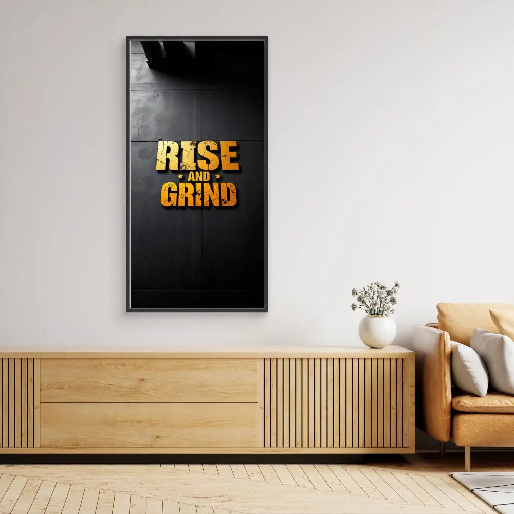 Black framed motivational wall art displaying ’RISE AND GRIND’ in gold text.