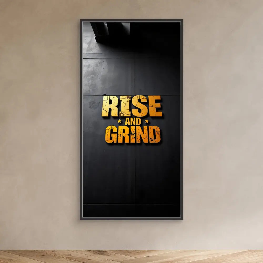 A black framed poster displaying ’RISE AND GRIND’ in gold textured lettering.