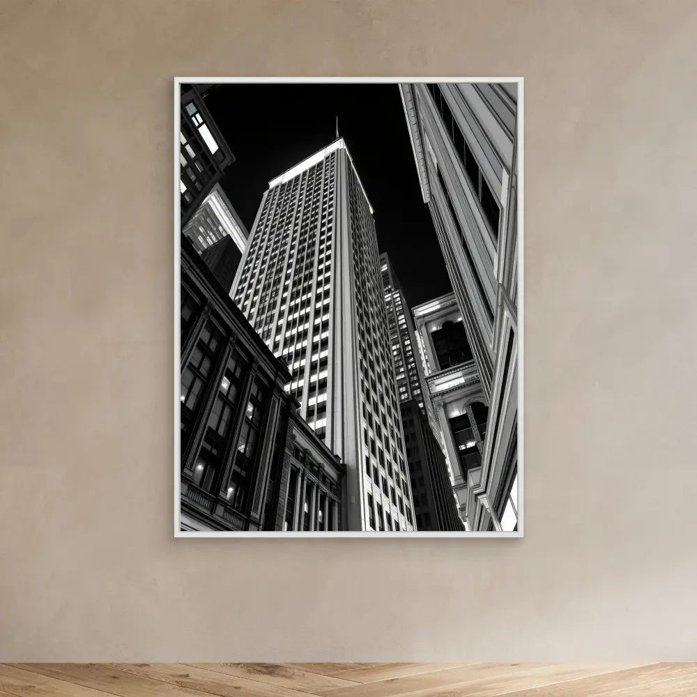 Black and white photograph of a skyscraper shot from a dramatic upward angle.