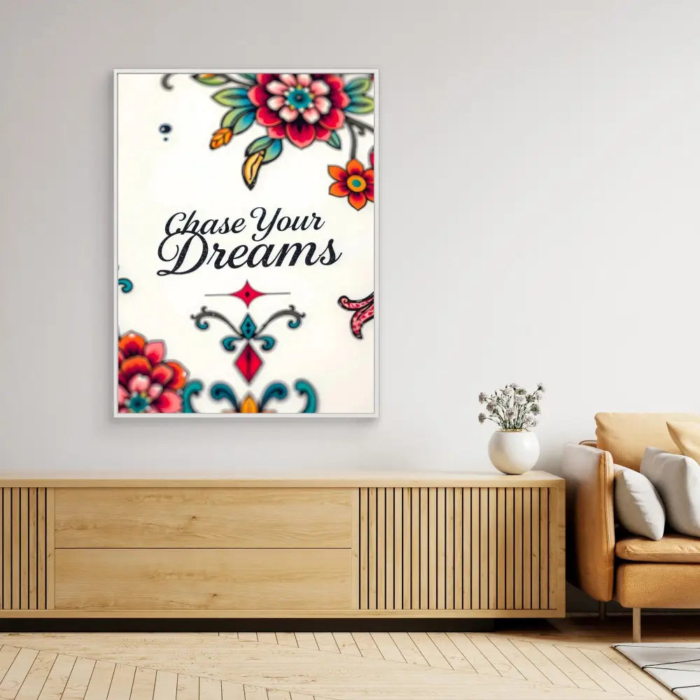 A decorative wall art print featuring floral designs and the text ’Chase Your Dreams’