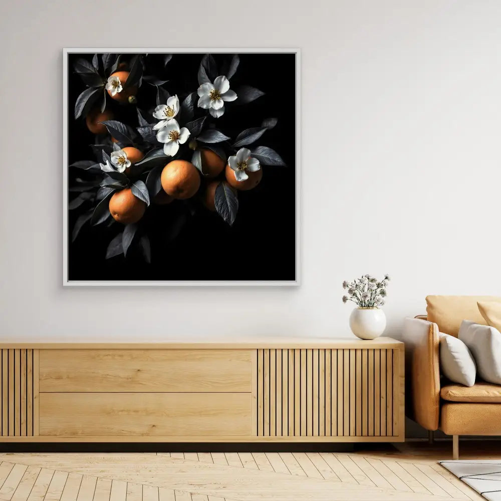 Dramatic black and white photograph of oranges and blossoms on branches.