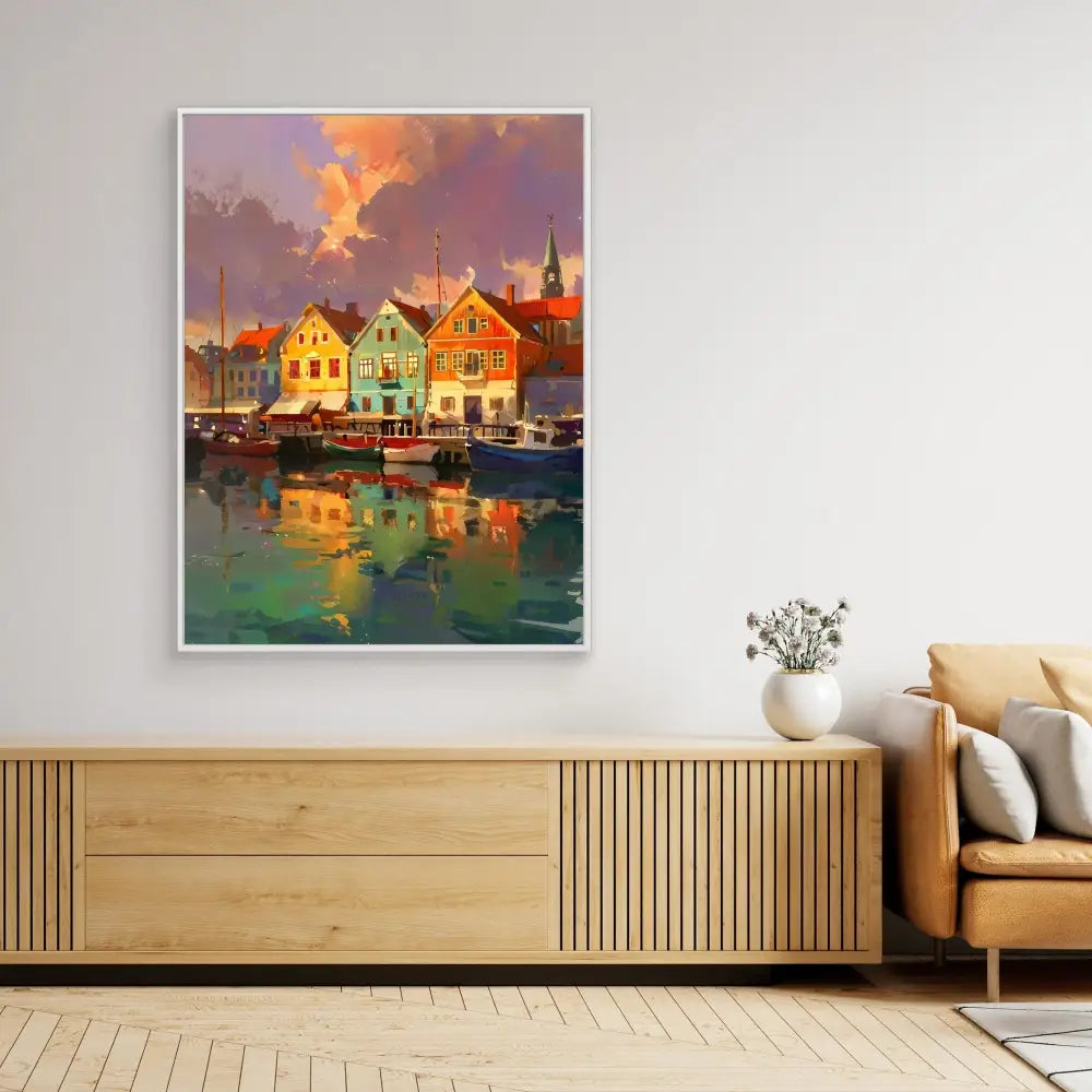 A framed artwork depicting colorful waterfront houses reflecting in calm harbor waters at sunset.