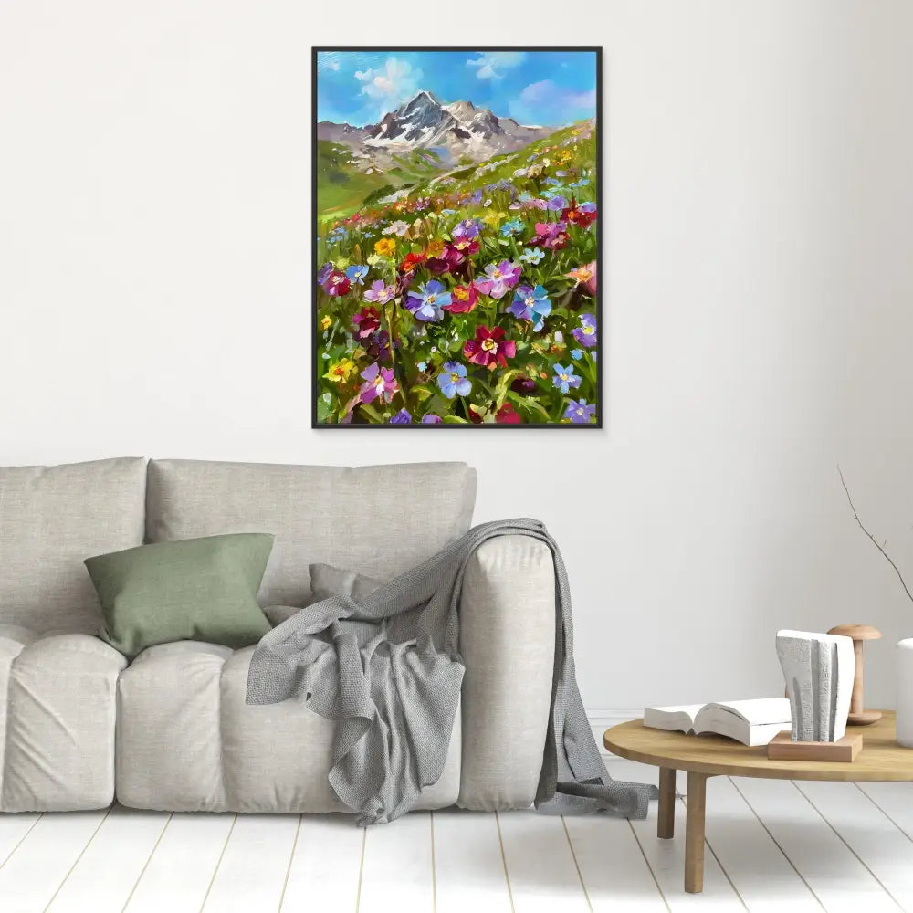 Framed artwork depicting colorful wildflowers blooming beneath mountain peaks.