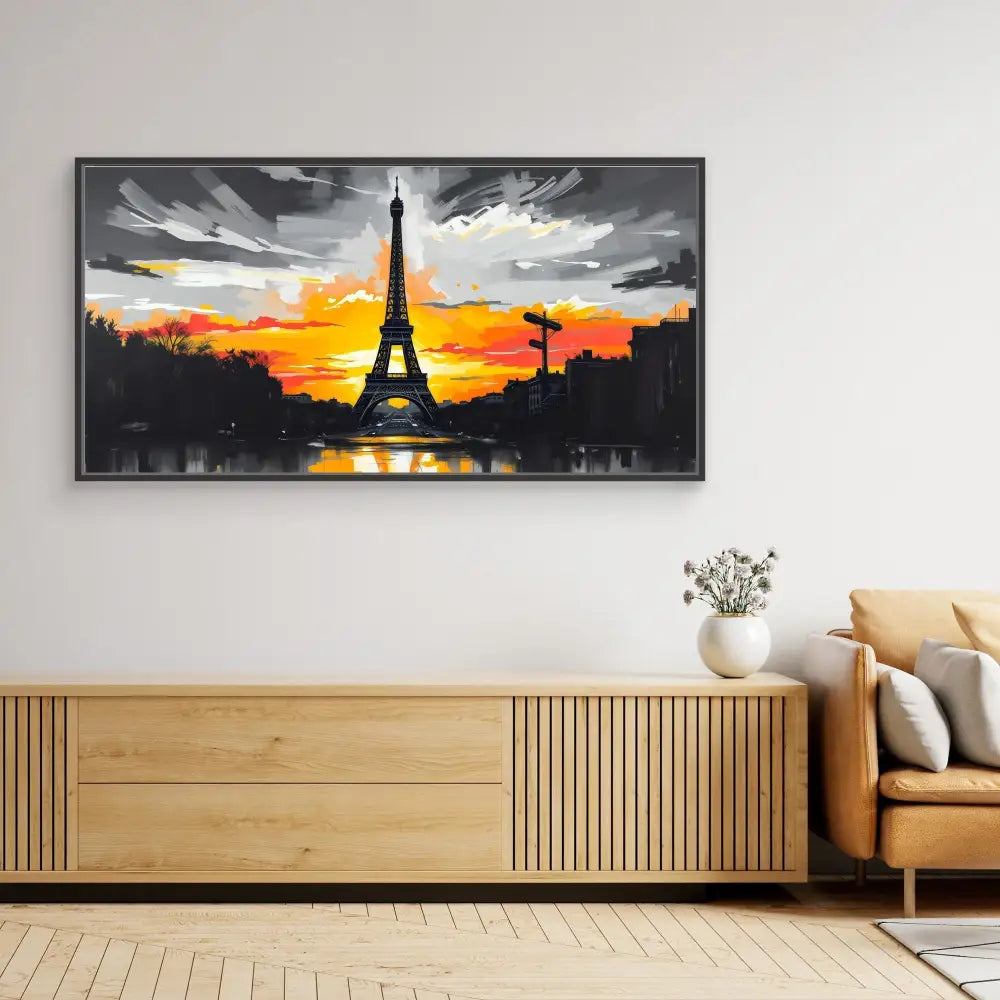 A framed artwork depicting the Eiffel Tower silhouetted against a vibrant orange sunset.