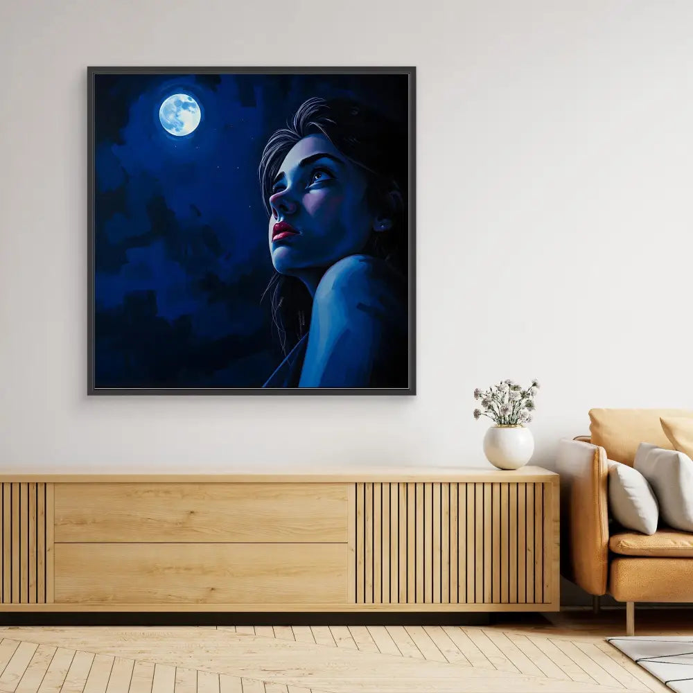 A framed artwork depicting a moonlit silhouette gazing upward in blue tones.