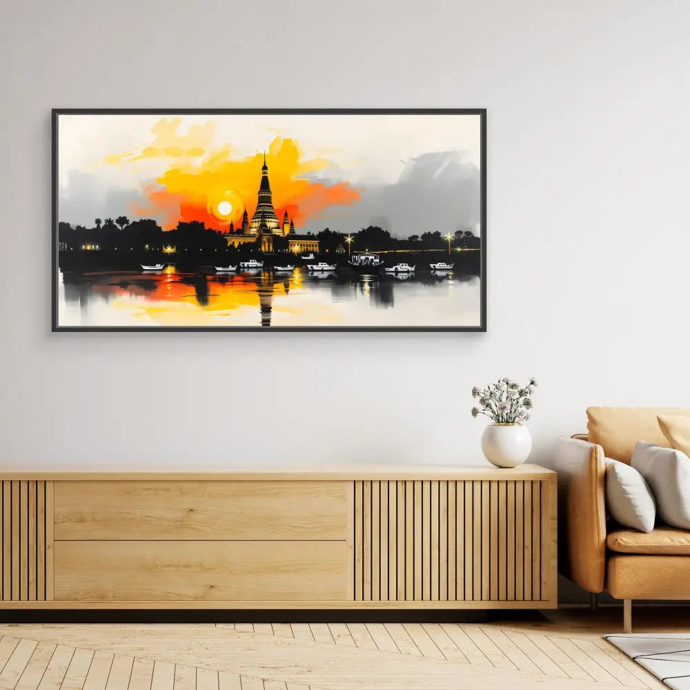 A framed artwork depicting a temple silhouette against an orange sunset reflected in water.