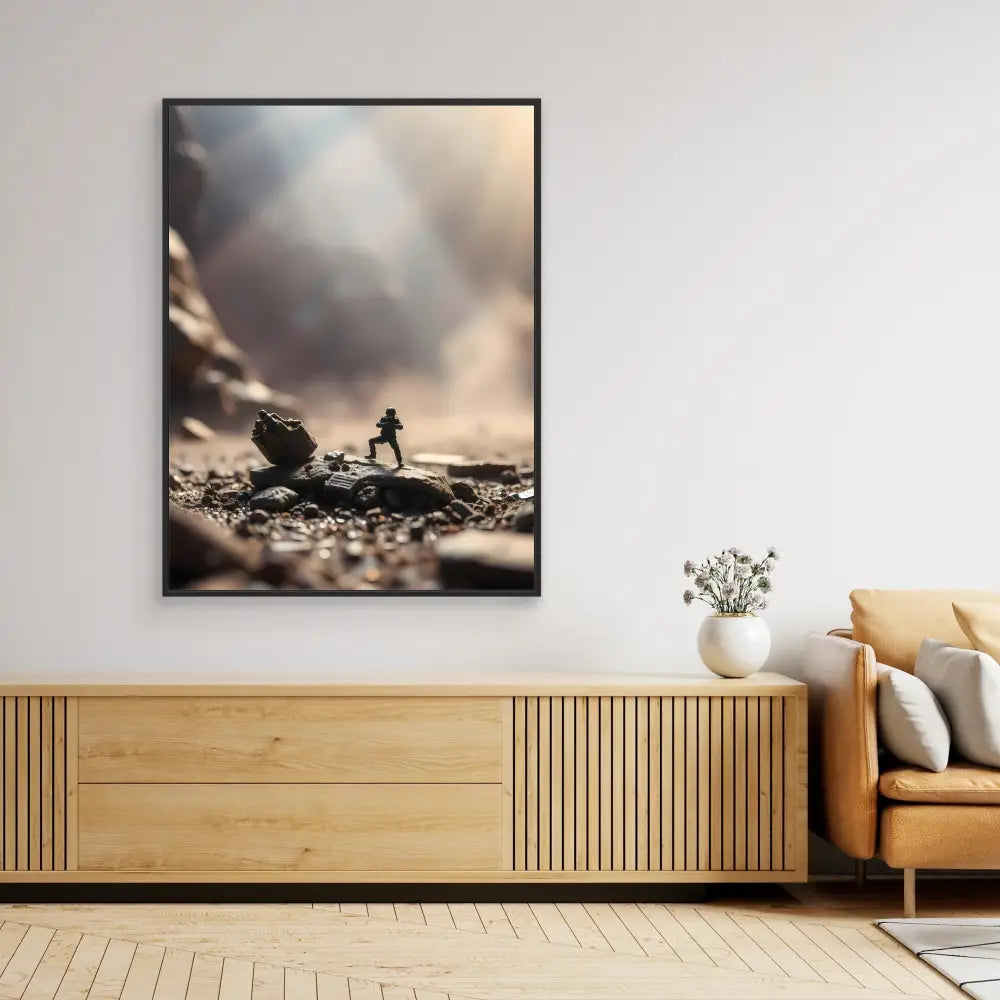 A framed dramatic photograph of a silhouetted figure pushing a boulder uphill.