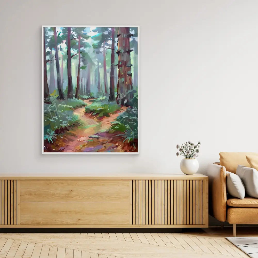 A framed forest path painting mounted above a wooden credenza.