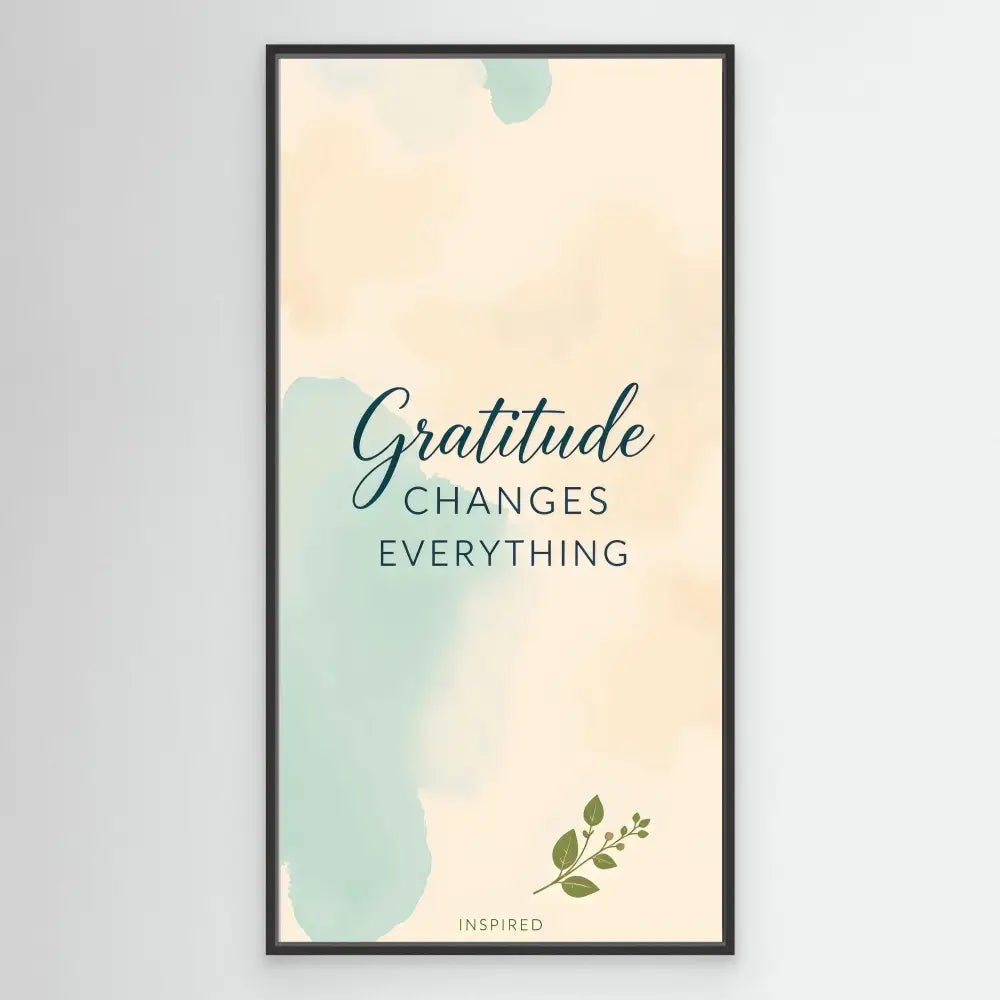 A framed inspirational quote reading ’Gratitude changes everything’ with mint green watercolor accents and a small leaf design.