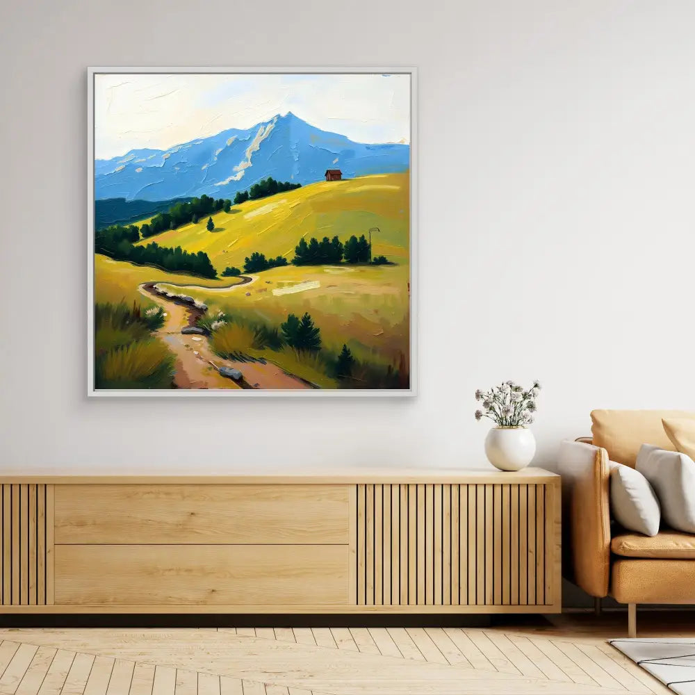 A framed landscape painting featuring golden hills, a winding path, and a mountain peak.