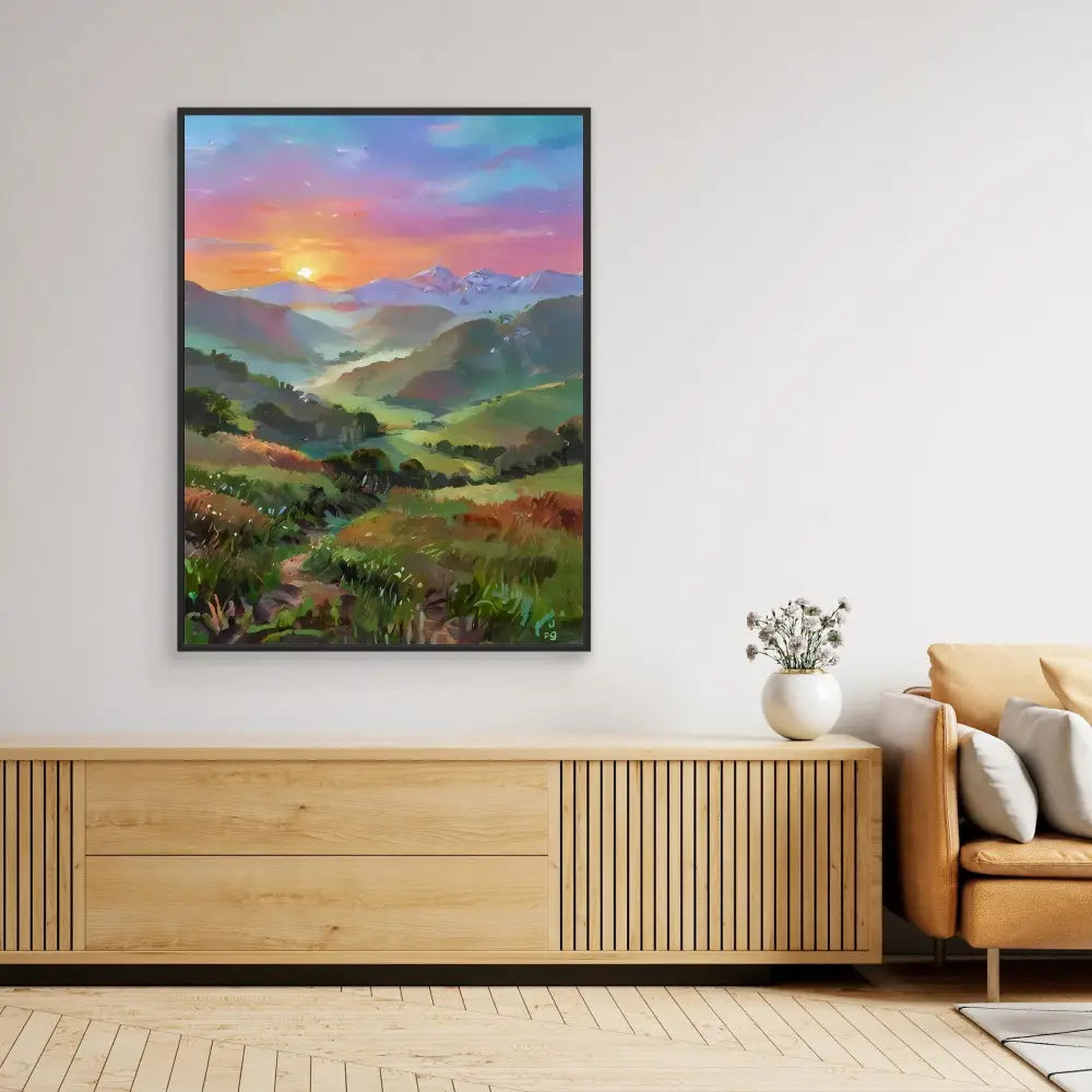 Framed landscape painting depicting rolling hills and a sunset with vibrant pink and orange skies.