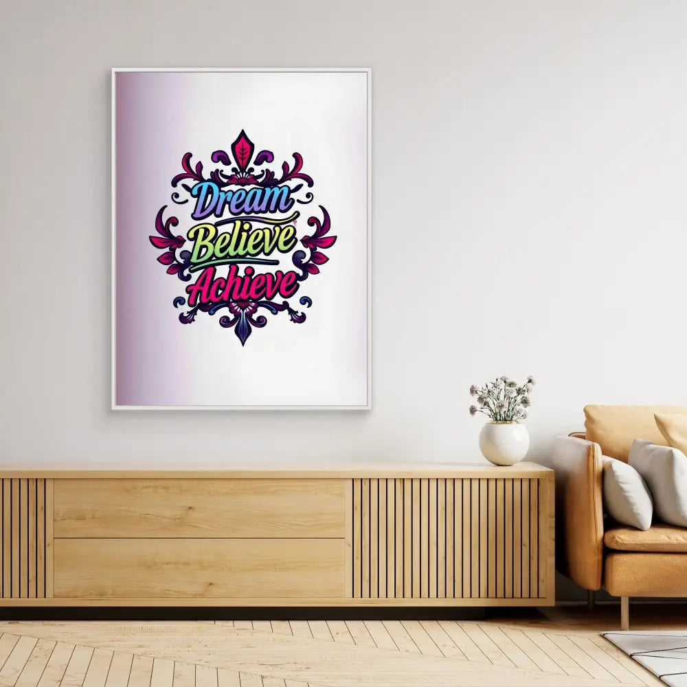 Framed motivational artwork displaying ’Dream Believe Achieve’ text with decorative floral elements in purple and green colors.