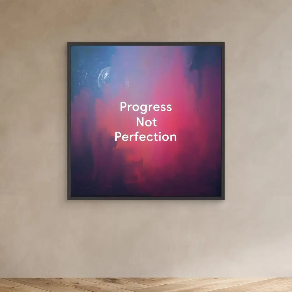 A framed motivational artwork displaying ’Progress Not Perfection’ text on a pink and purple gradient background.