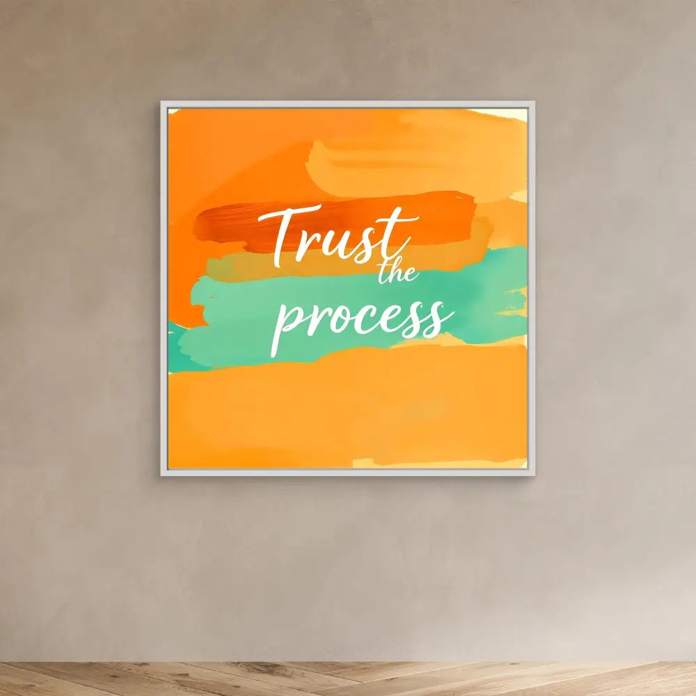 A framed motivational artwork featuring ’Trust the process’ text on orange and mint green brushstrokes.