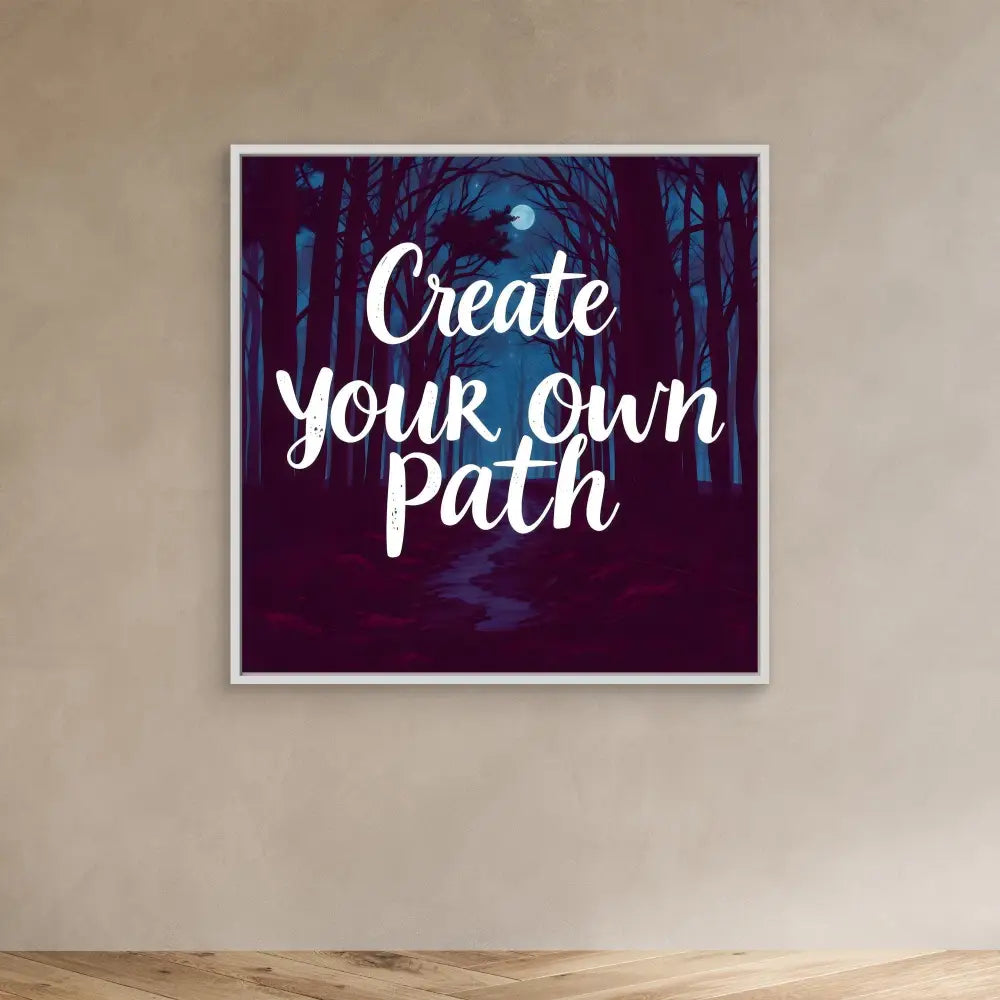 A framed motivational artwork featuring white text ’Create your own path’ against a dark forest scene with a moon.