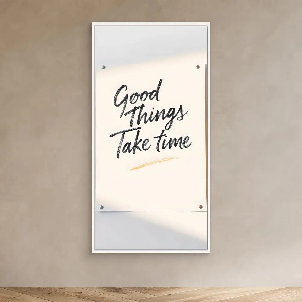 A framed motivational quote reading ’Good Things Take Time’ mounted on a wall.