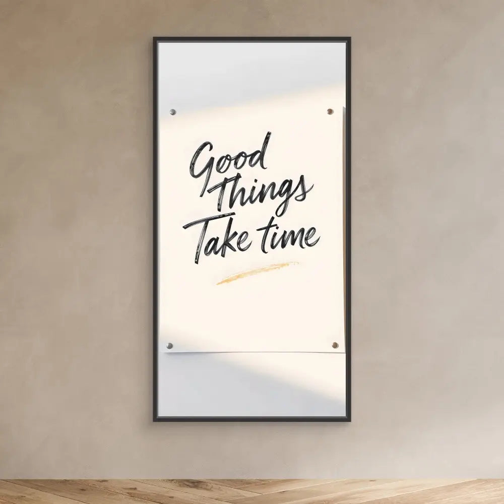 A framed motivational quote reading ’Good Things Take Time’ mounted on a wall.