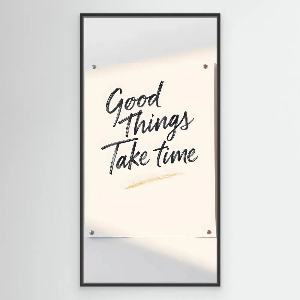 A framed motivational quote reading ’Good Things Take Time’ mounted on a wall.