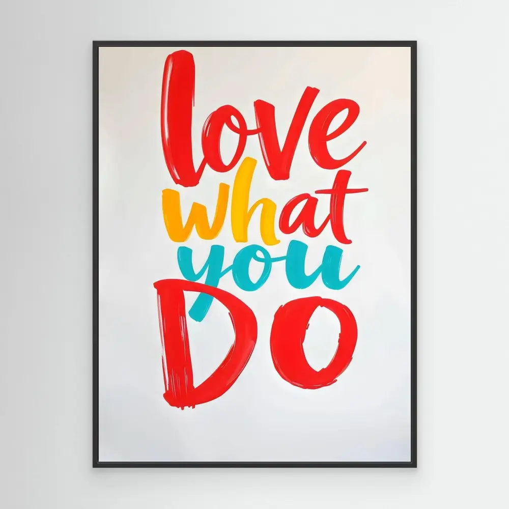 A framed motivational text artwork reading ’love what you do’ in red, yellow and turquoise brush lettering.