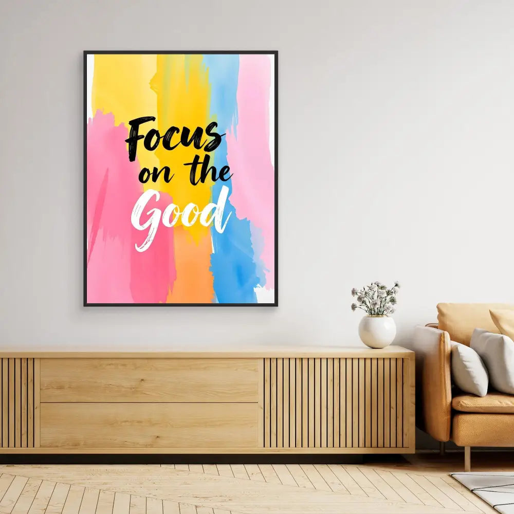 Framed motivational wall art with ’Focus on the Good’ text on a colorful watercolor background.