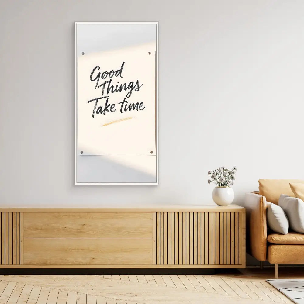 A framed motivational wall art displaying the text ’Good Things Take Time’