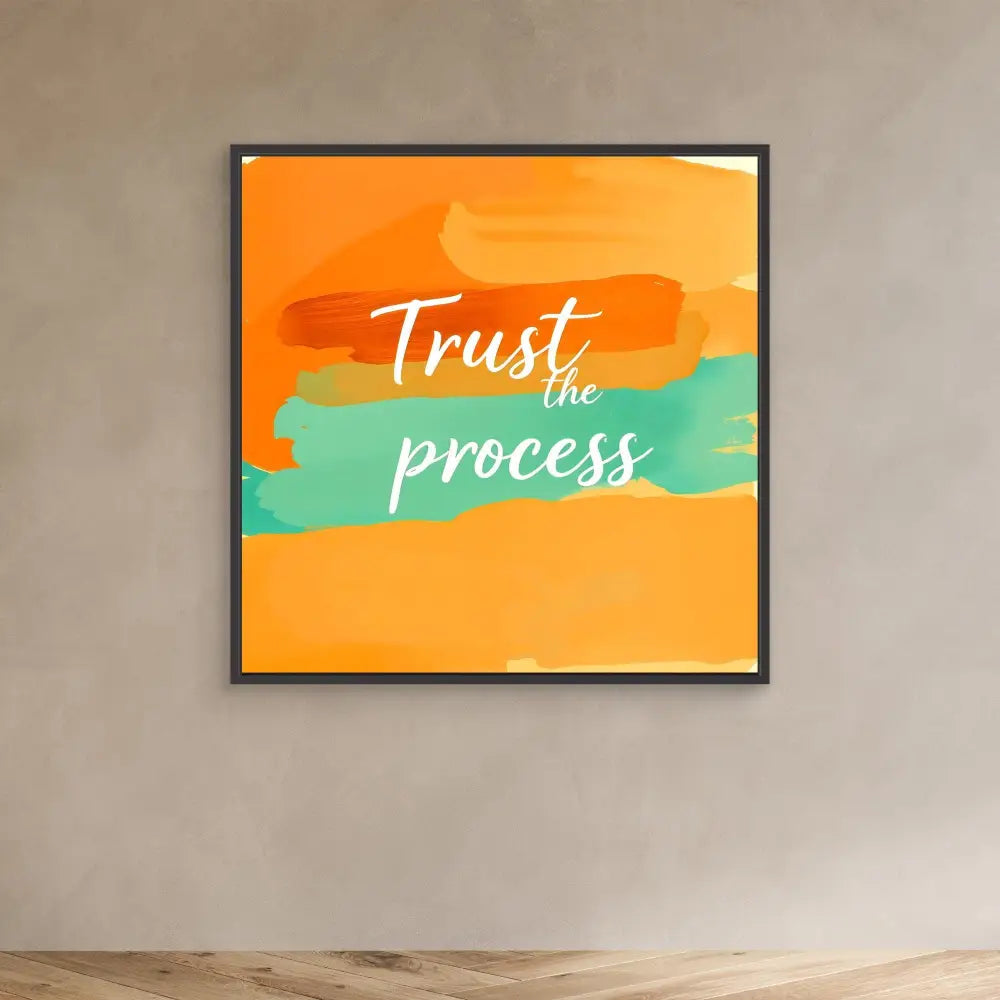 A framed motivational wall art featuring ’Trust the process’ text on orange and teal brushstrokes.