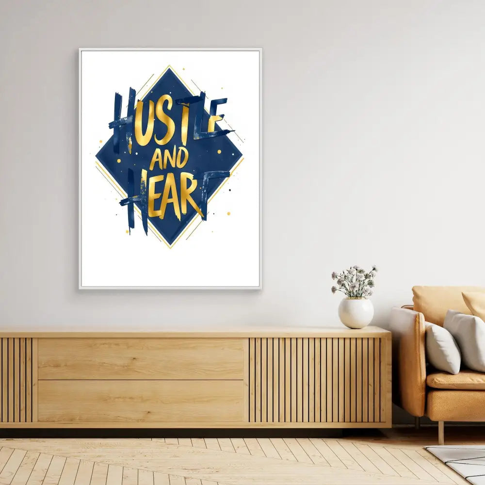 A framed navy blue and yellow ’Hustle and Fear’ typography art print.