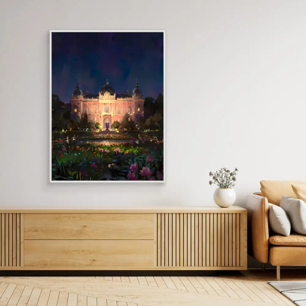 A framed photograph of an illuminated palace at twilight with a garden in the foreground hangs on a wall.