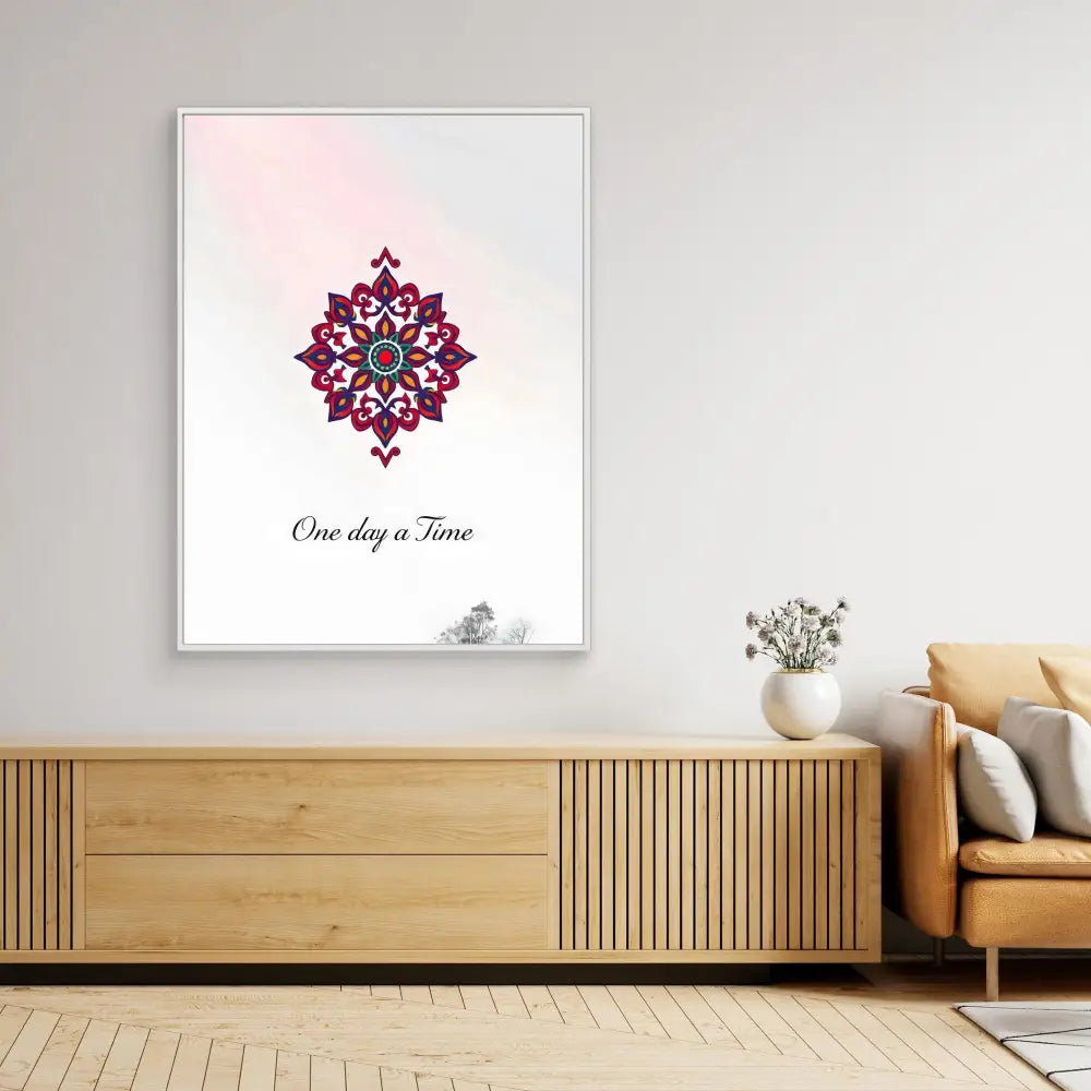 A framed wall print featuring a pink and blue mandala design with text reading ’One day a Time’