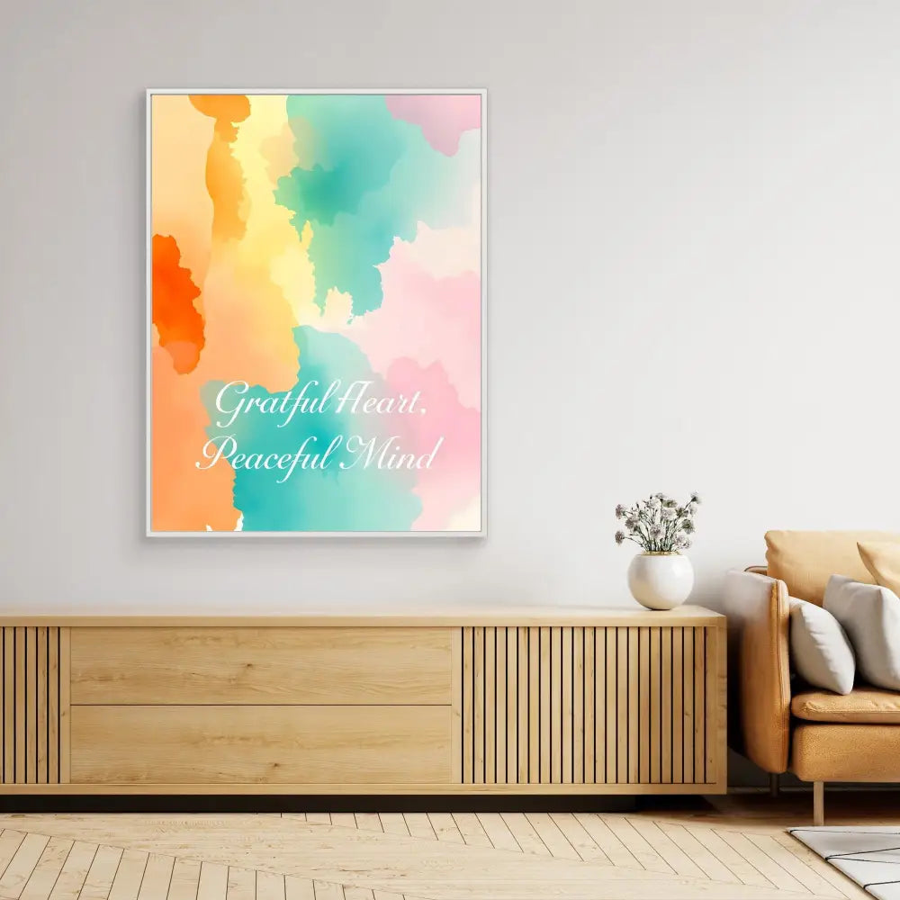 Framed watercolor artwork with text ’Grateful Heart Peaceful Mind’ in pastel orange, turquoise and pink tones.