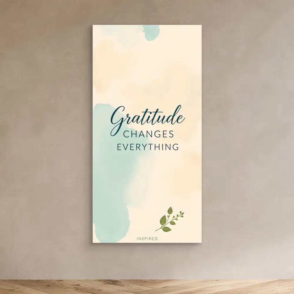 Inspirational wall art featuring the quote ’Gratitude Changes Everything’ in a mint green and cream color scheme with a small leaf accent.