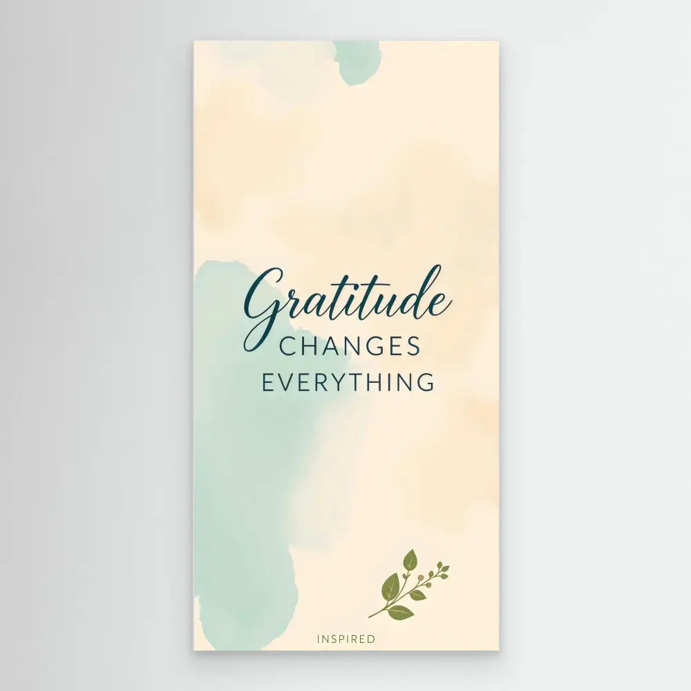 A mint green and cream colored motivational card featuring the text ’Gratitude changes everything’ with a small leaf decoration.