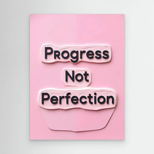 A motivational quote reading ’Progress Not Perfection’ on torn paper pieces against a pink surface.