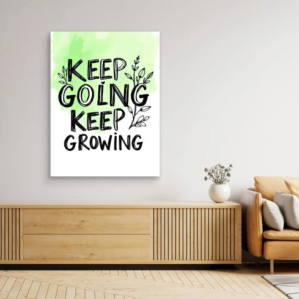 Motivational wall art featuring black text ’KEEP GOING KEEP GROWING’ with leaf accents on a green-to-white gradient background.