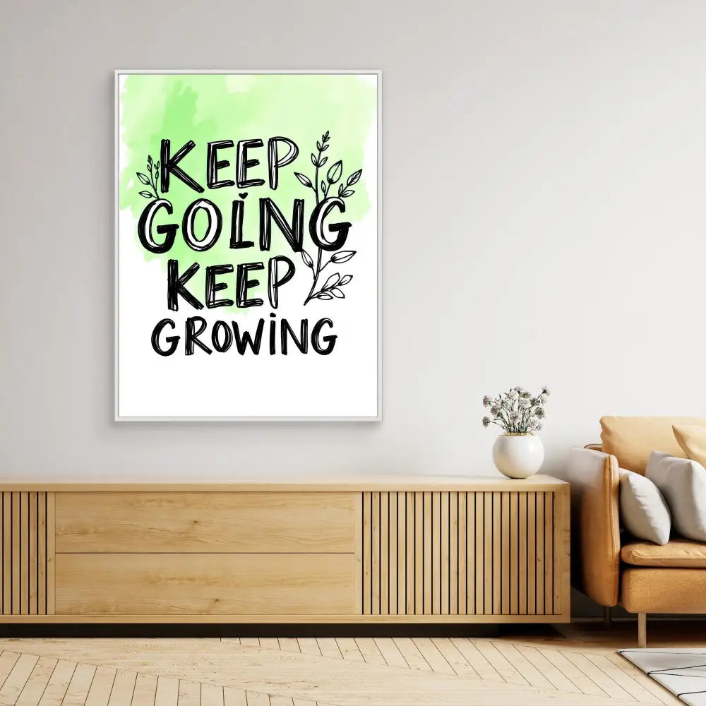 Motivational wall art featuring black text ’KEEP GOING KEEP GROWING’ with leaf designs on a green gradient background.