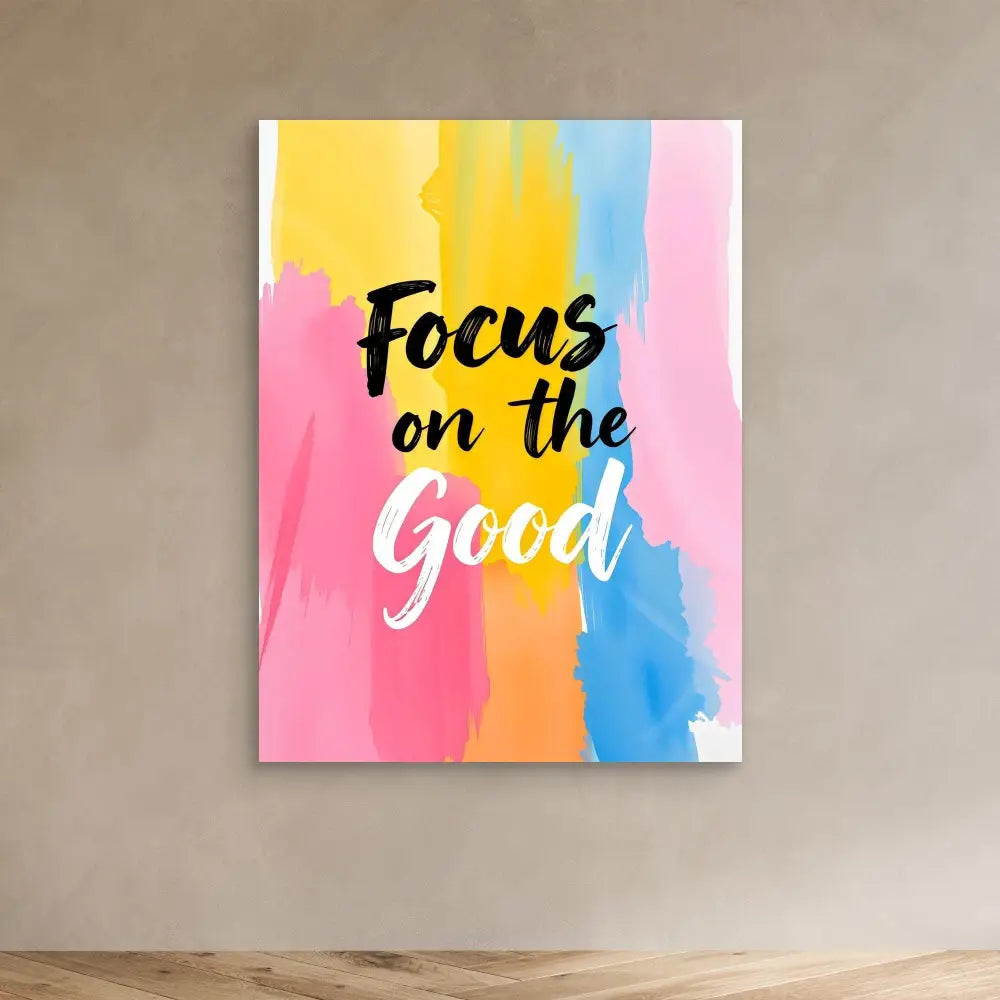 Motivational wall art with ’Focus on the Good’ text on a colorful watercolor background.