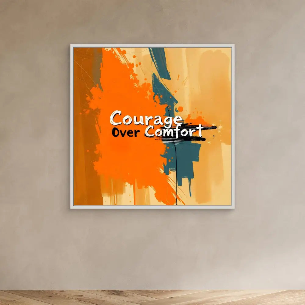 A motivational wall art piece featuring the text ’Courage Over Comfort’ on an orange and teal abstract paint splash design.