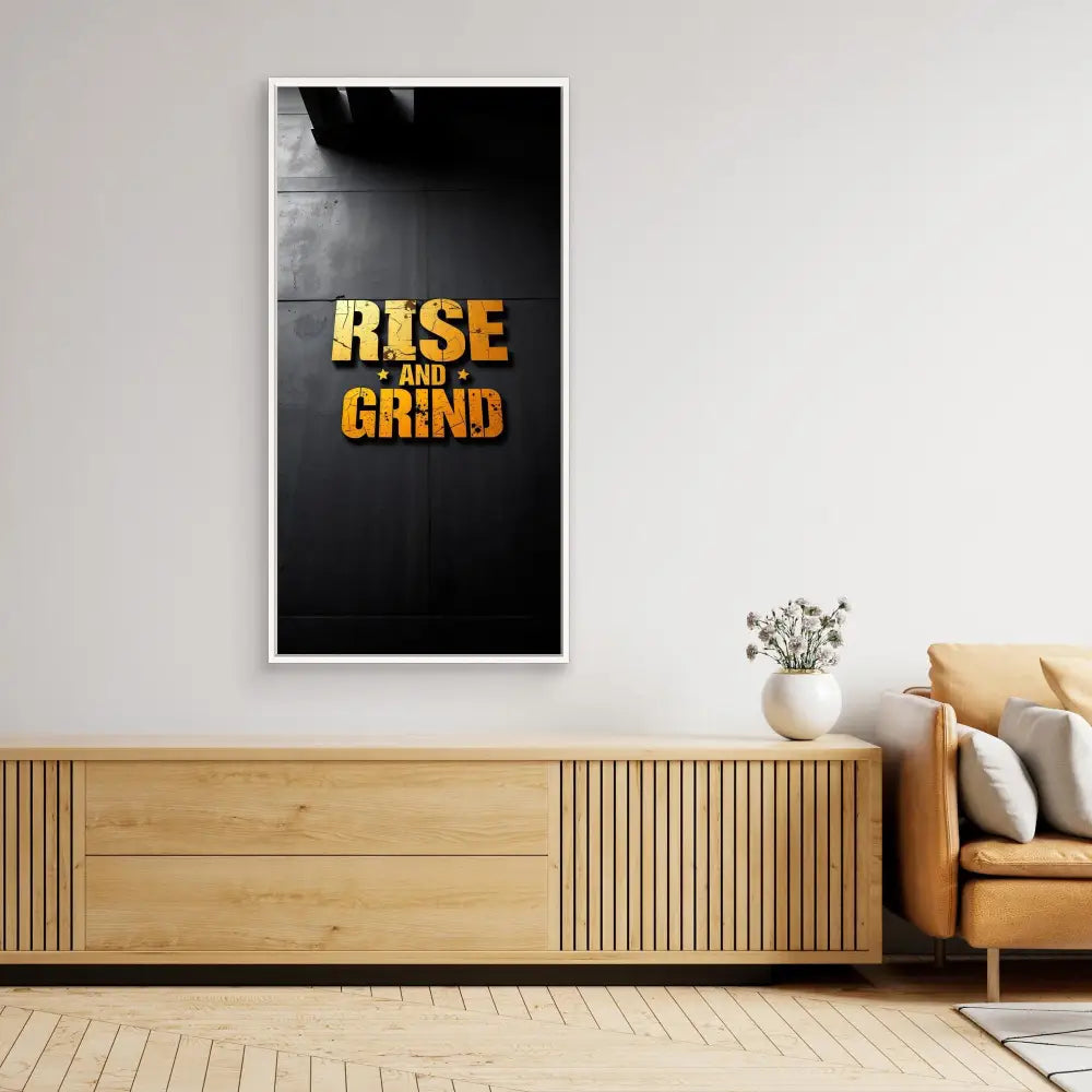 Motivational wall art displaying ’RISE AND GRIND’ in gold text against a black background.