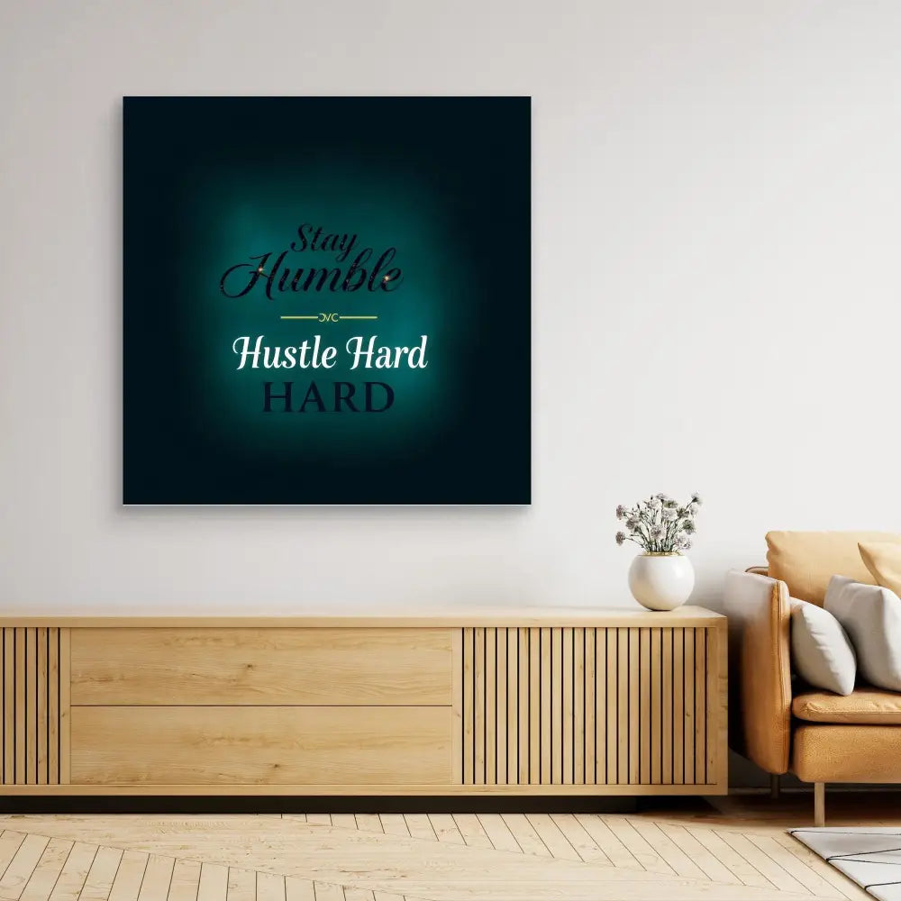 Motivational wall art with text ’Stay Humble Hustle Hard’ on a dark teal background.