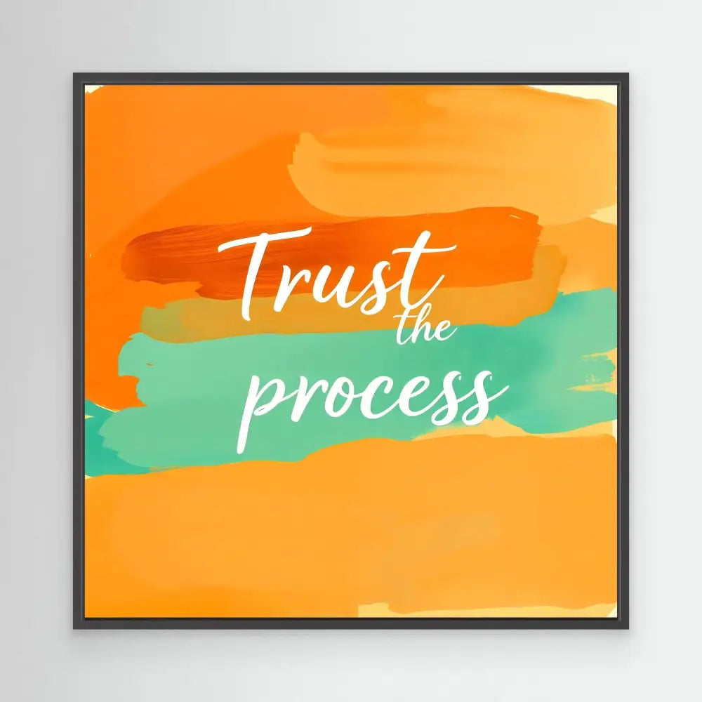 Motivational wall art with ’Trust the process’ text on orange and teal watercolor brushstrokes.