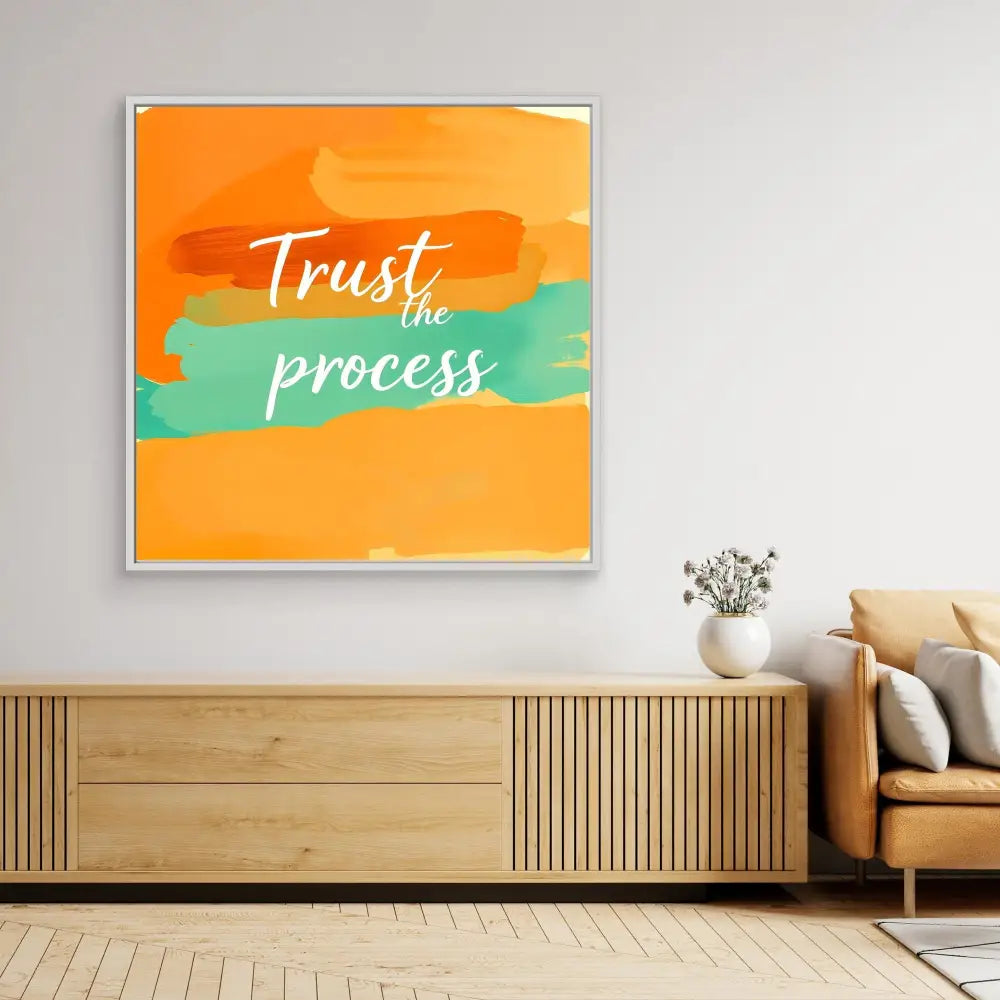 Motivational wall art featuring ’Trust the process’ text on orange and teal brushstrokes.