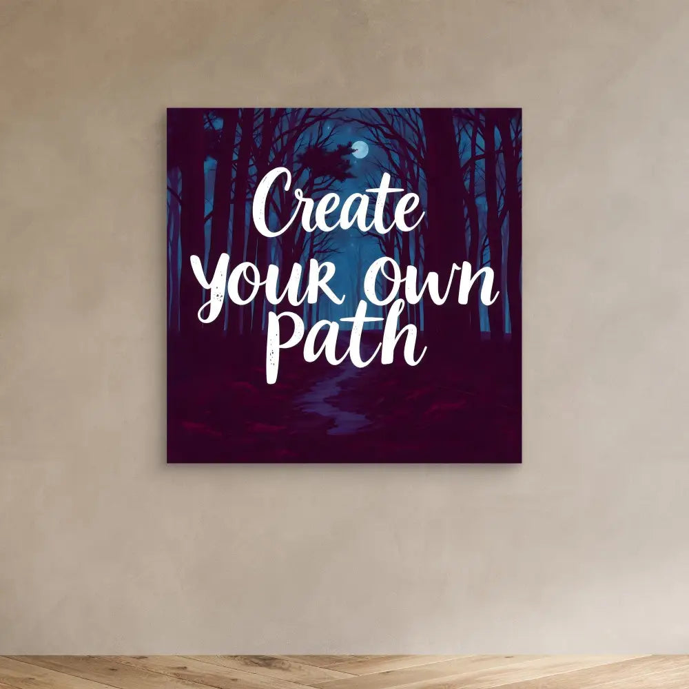 Motivational wall art featuring white text ’Create your own path’ on a dark forest background with a moon.