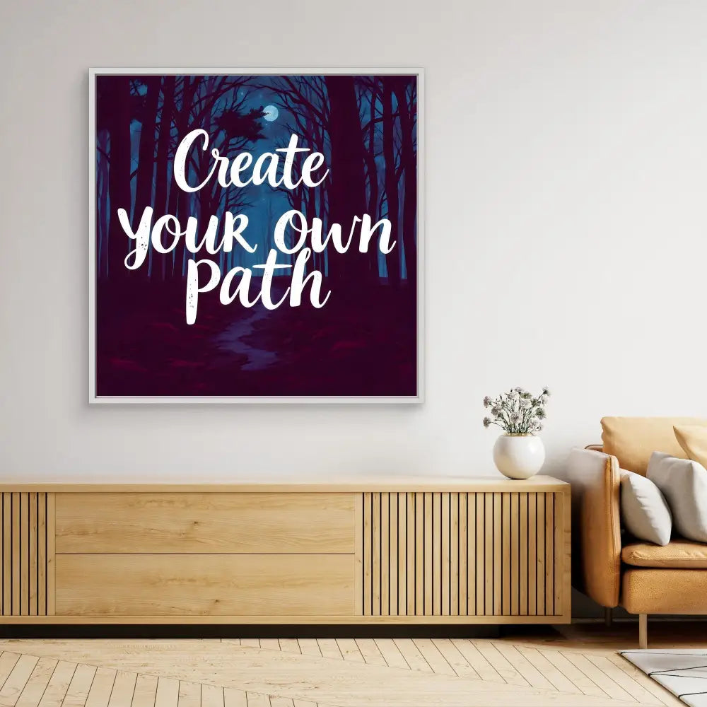 Motivational wall art featuring white text ’Create your own path’ on a dark forest background.