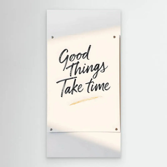 A motivational wall sign with handwritten text reading ’Good Things Take Time’