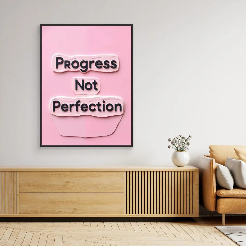 Pink framed wall art displaying the text ’Progress Not Perfection’